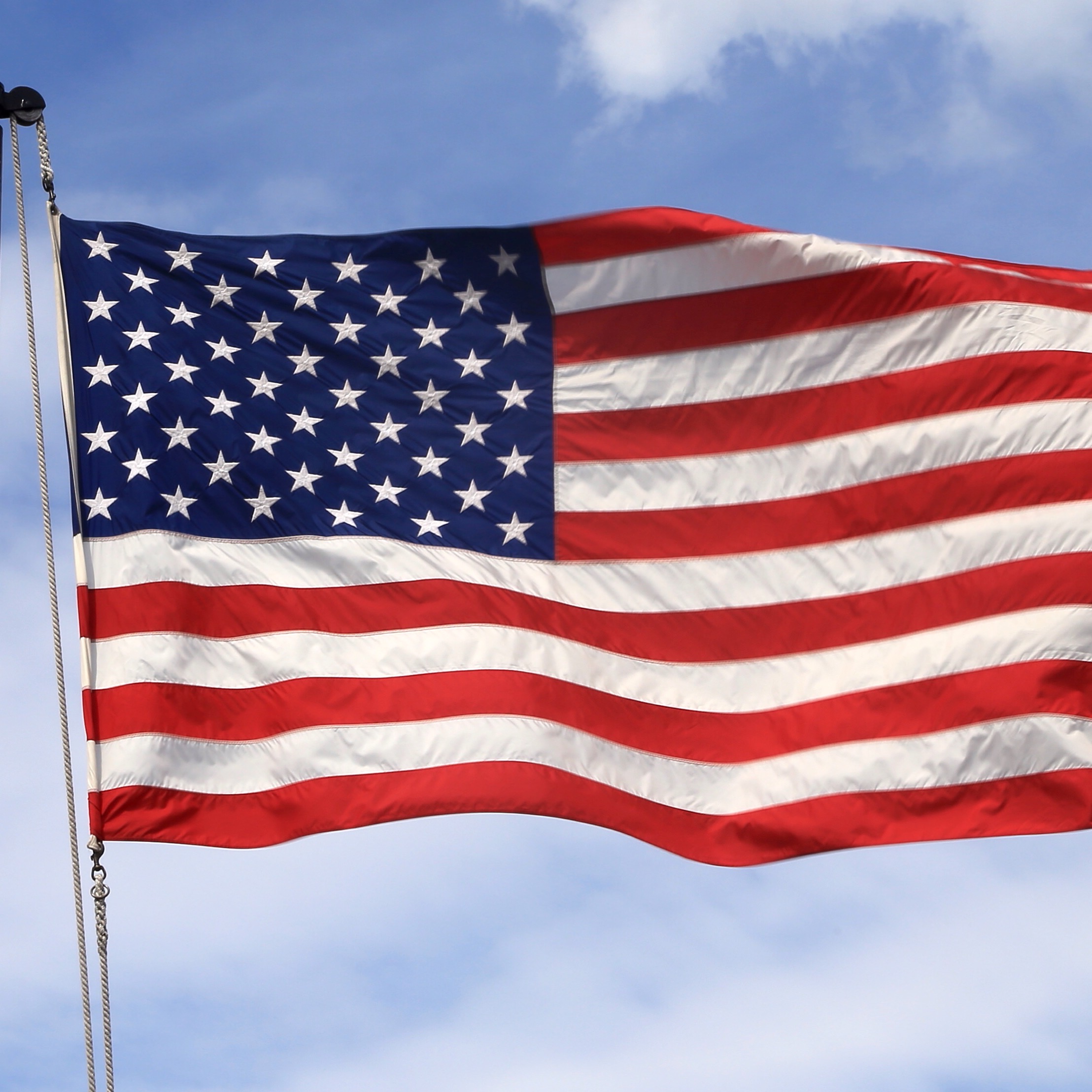 US Flag flying over the USS Constitution in Boston Harbor.